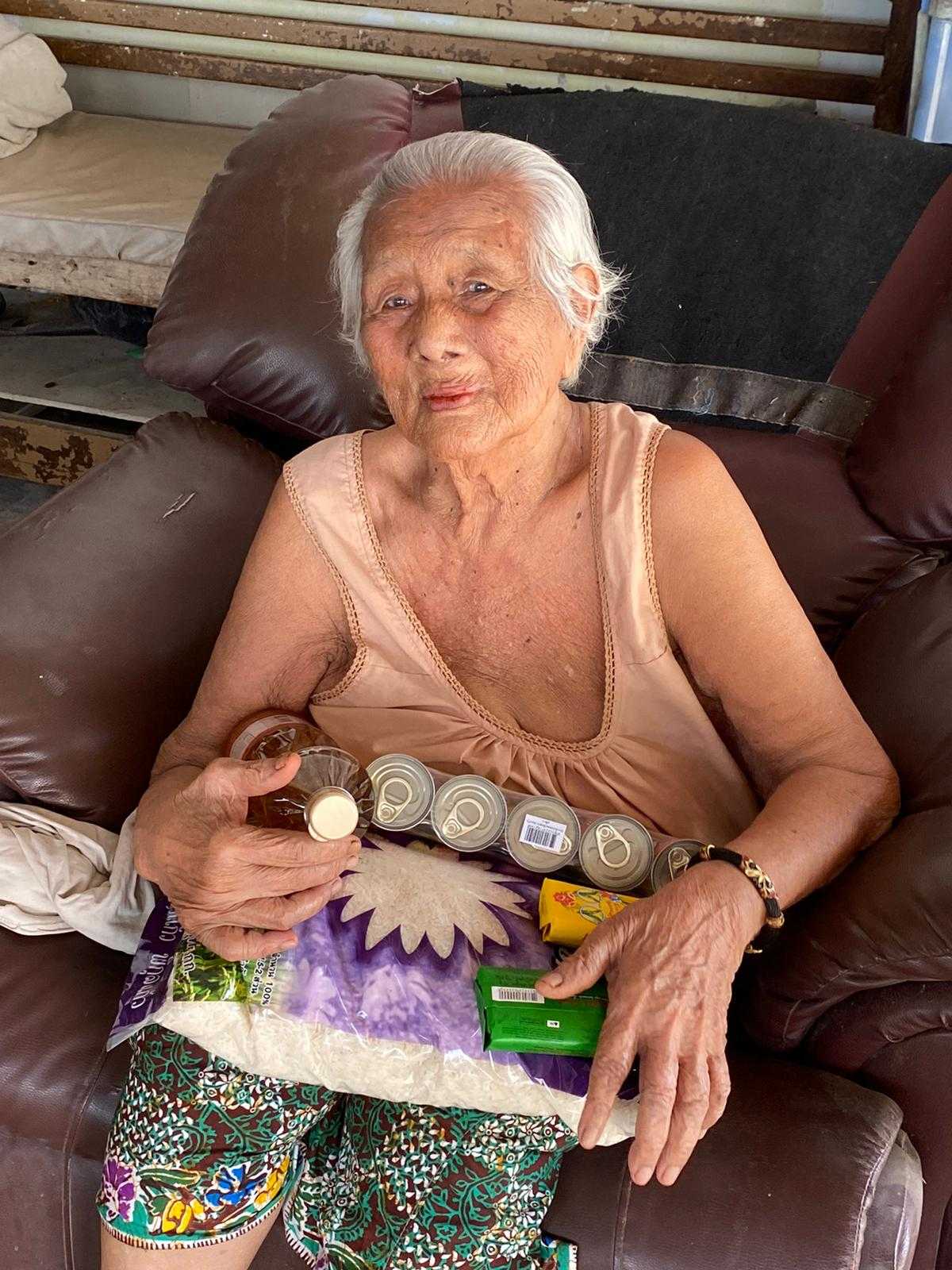 an elderly woman with food parcel